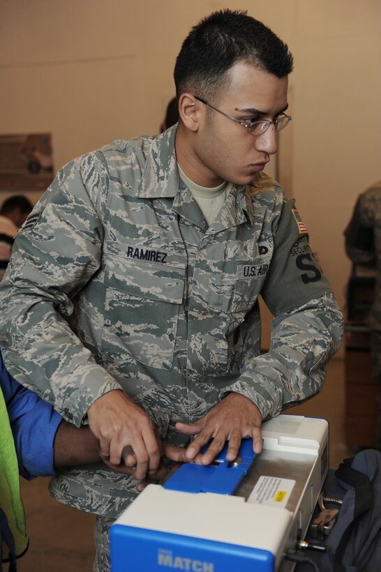 Senior Airman Juan Ramirez processes a third country national into the Defense Biometrics Identification System Aug. 2 in Southwest Asia. DBIDS is an enhanced security system used to monitor entry onto military installations. Airman Ramirez is 379th Expeditionary Security Forces Squadron DBIDS registrar. He is deployed from Maxwell Air Force Base, Ala., and a native of Laredo, Texas. (U.S. Air Force photo/Staff Sgt. Robert Barney) 
