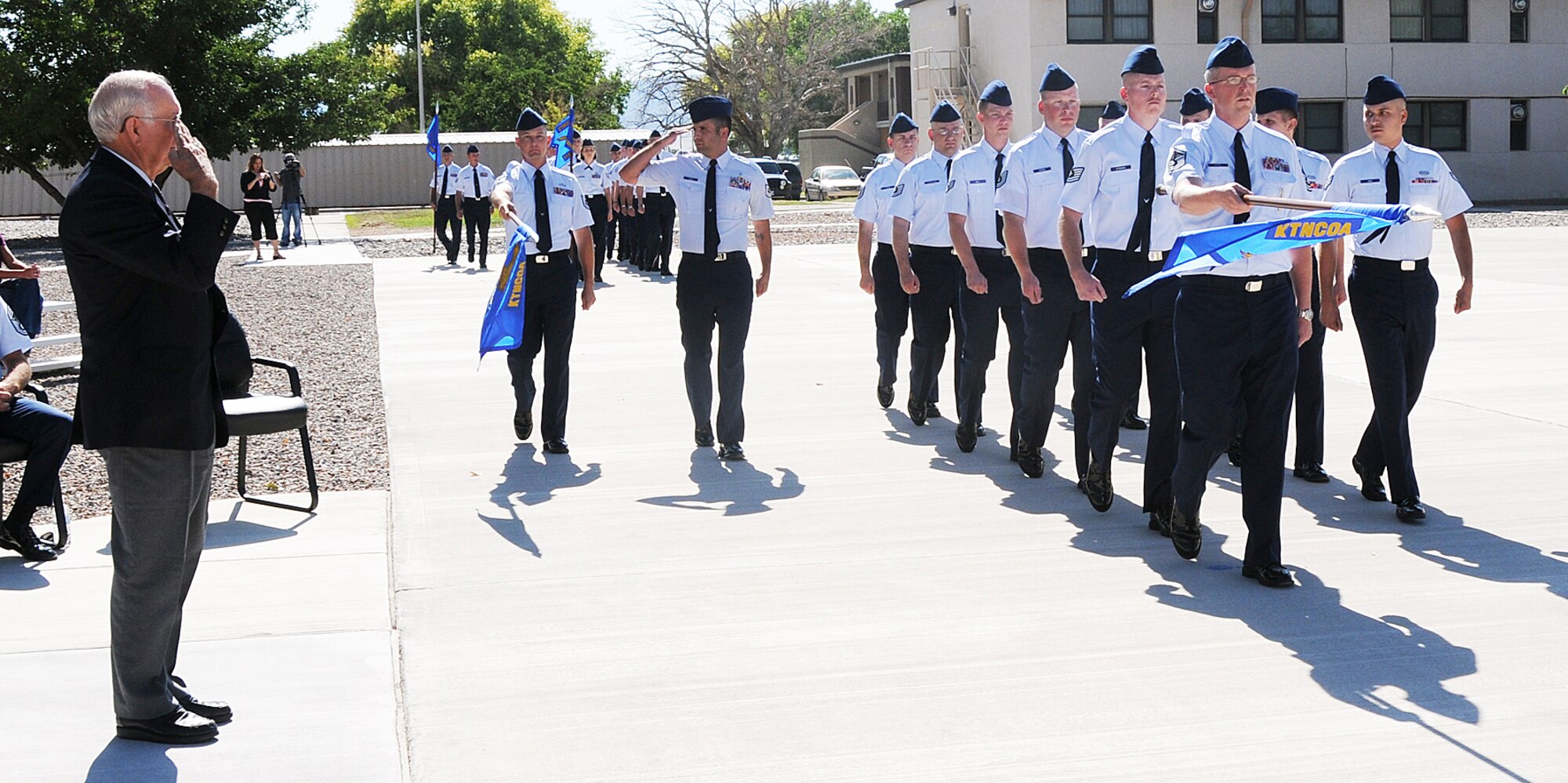 Retired eighth Chief Master Sergeant of the Air Force Sam Parish receives the last salute of the Kirtland AFB Noncommissioned Officer Academy during a pass in review, July 31. U.S. Photo by Dennis Carlson