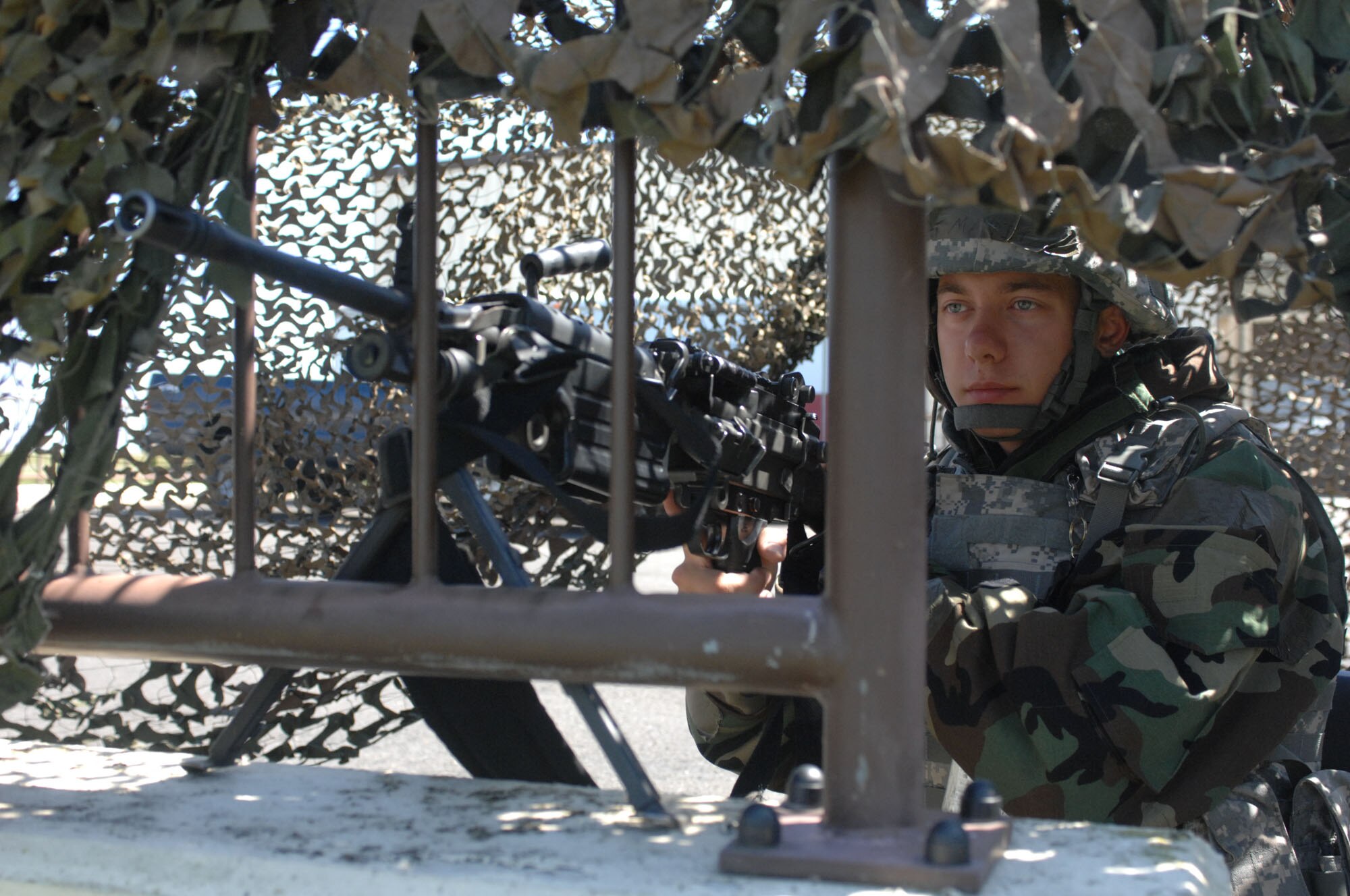 SPANGDAHLEM AIR BASE, Germany -- Airman 1st Class Timothy Mauritz, 52nd Security Forces Squadron heavy machine gunner, stands guard as a sentry for the entry control point located by hangar 3 Aug. 5 during the 52nd Fighter Wing’s Phase II exercise. Spangdahlem Airmen practiced proper entry control procedures and how to respond when an entry control point is disabled, as well as practicing emergency response and defense procedures. (U.S. Air Force photo/Senior Airman Jenifer H. Calhoun)   