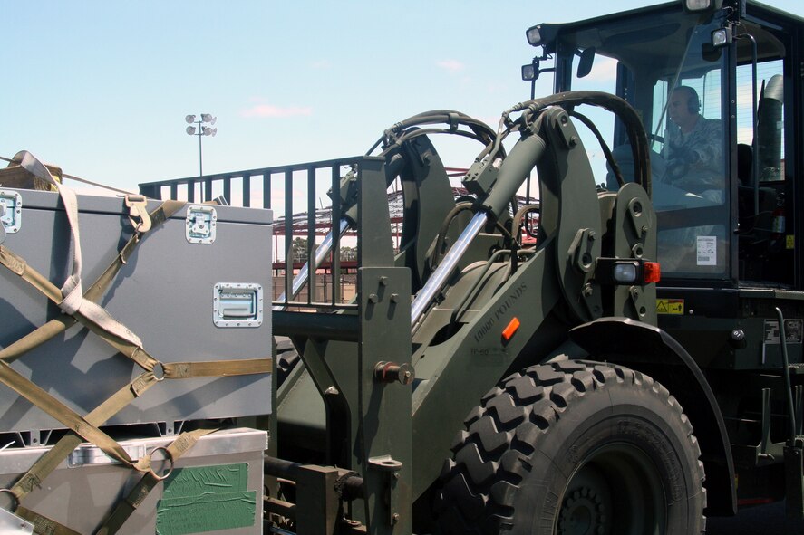 Tech. Sgt. John Fetter, air transportation craftsman for the 573rd Global Support Squadron at Travis Air Force Base, Calif., drives an all-terrain forklift into position to move a pallet at the unit's deployment warehouse Aug. 6, 2009.  The 573rd GSS is part of the 615th Contingency Response Wing at Travis AFB.  CRWs are Air Mobility Command's quick reaction force for humanitarian relief missions and for opening air bases any where in the world.  (U.S. Air Force Photo/Tech. Sgt. Scott T. Sturkol)