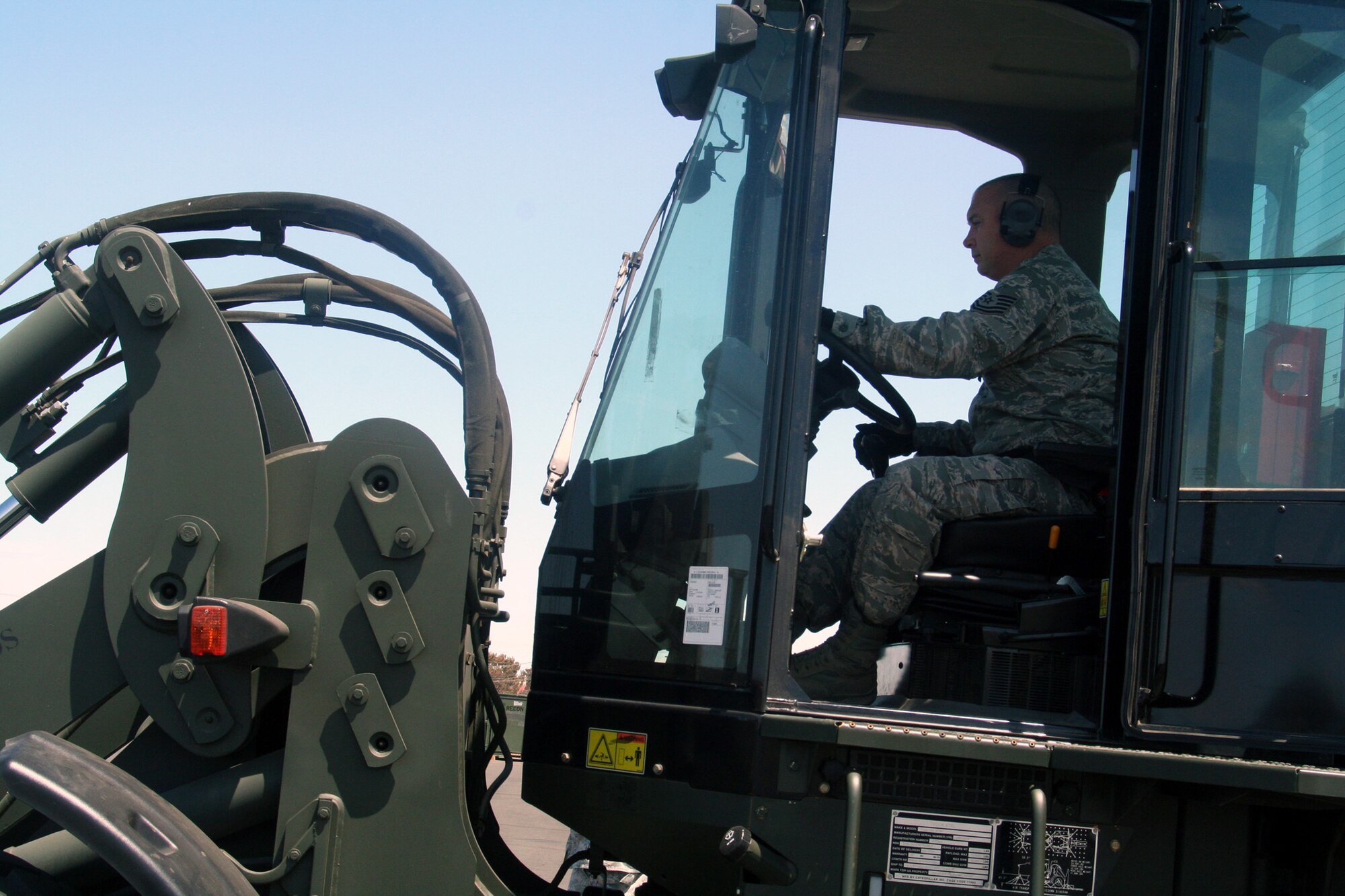 Tech. Sgt. John Fetter, air transportation craftsman for the 573rd Global Support Squadron at Travis Air Force Base, Calif., drives an all-terrain forklift into position to move a pallet at the unit's deployment warehouse Aug. 6, 2009.  The 573rd GSS is part of the 615th Contingency Response Wing at Travis AFB.  CRWs are Air Mobility Command's quick reaction force for humanitarian relief missions and for opening air bases any where in the world.  (U.S. Air Force Photo/Tech. Sgt. Scott T. Sturkol)