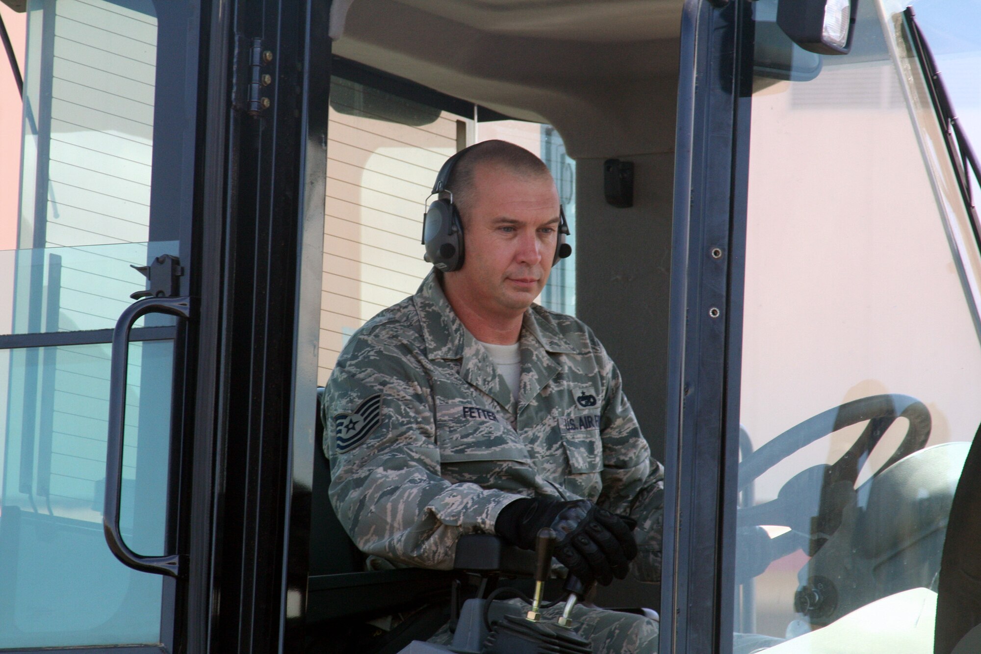 Tech. Sgt. John Fetter, air transportation craftsman for the 573rd Global Support Squadron at Travis Air Force Base, Calif., drives an all-terrain forklift into position to move a pallet at the unit's deployment warehouse Aug. 6, 2009.  The 573rd GSS is part of the 615th Contingency Response Wing at Travis AFB.  CRWs are Air Mobility Command's quick reaction force for humanitarian relief missions and for opening air bases any where in the world.  (U.S. Air Force Photo/Tech. Sgt. Scott T. Sturkol)
