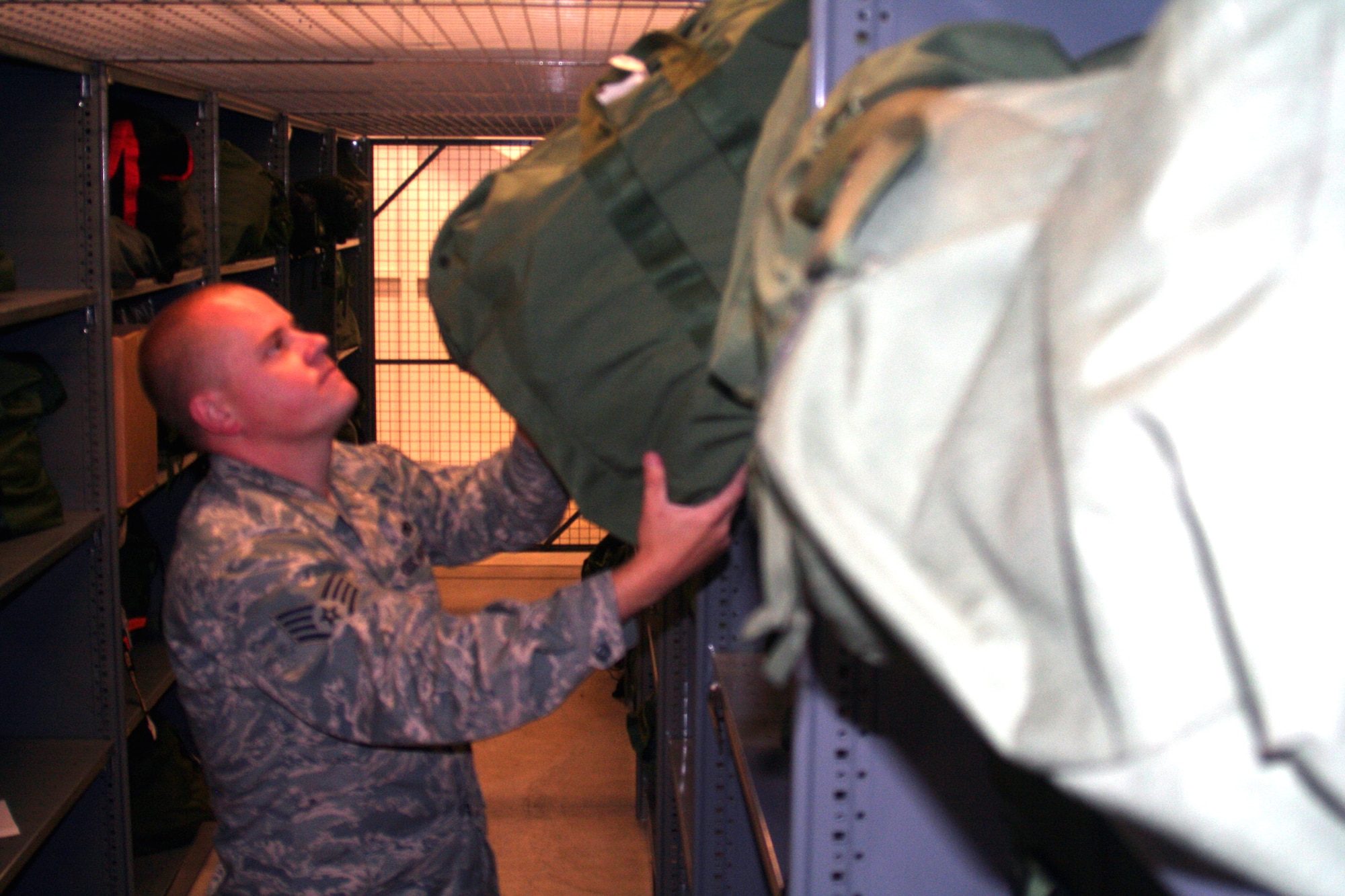 Staff Sgt. Johnny Hudson, from the 573rd Global Support Squadron at Travis Air Force Base, Calif., prepares some deployment kits at the unit's deployment warehouse Aug. 6, 2009.  The 573rd GSS is part of the 615th Contingency Response Wing at Travis Air Force Base, Calif.  CRWs are Air Mobility Command's quick reaction force for humanitarian relief missions and for opening air bases any where in the world.  (U.S. Air Force Photo/Tech. Sgt. Scott T. Sturkol)