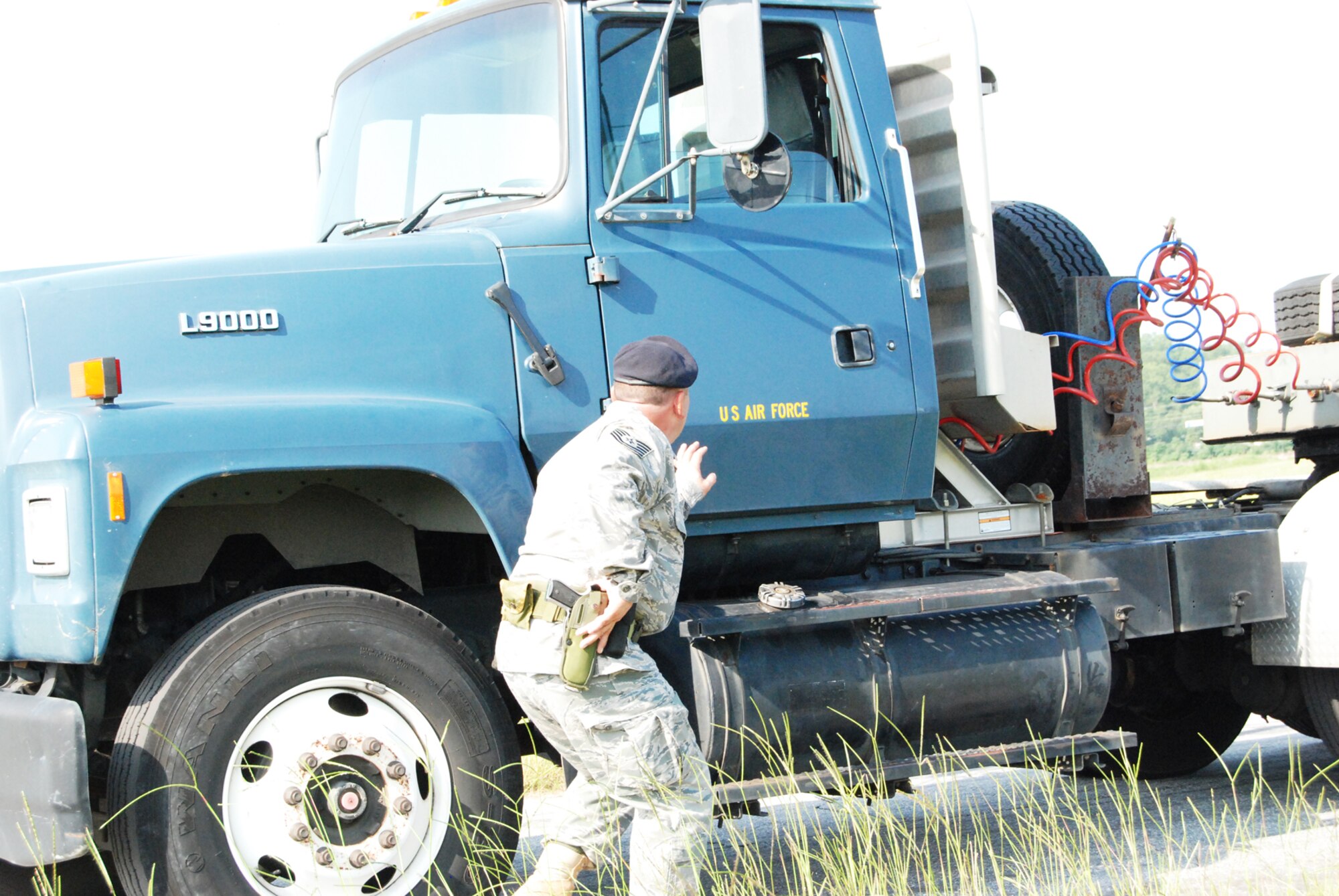 Tech. Sgt. Russell Jones, 94th Security Forces Squadron, searches the vehicle of a suspect who was recently detained for entering the base without authorization during an exercise Aug. 6. The excercise focused on the proper procedure regarding unauthorized vehicles entering the base. (U.S. Air Force photo/Kennith Green)