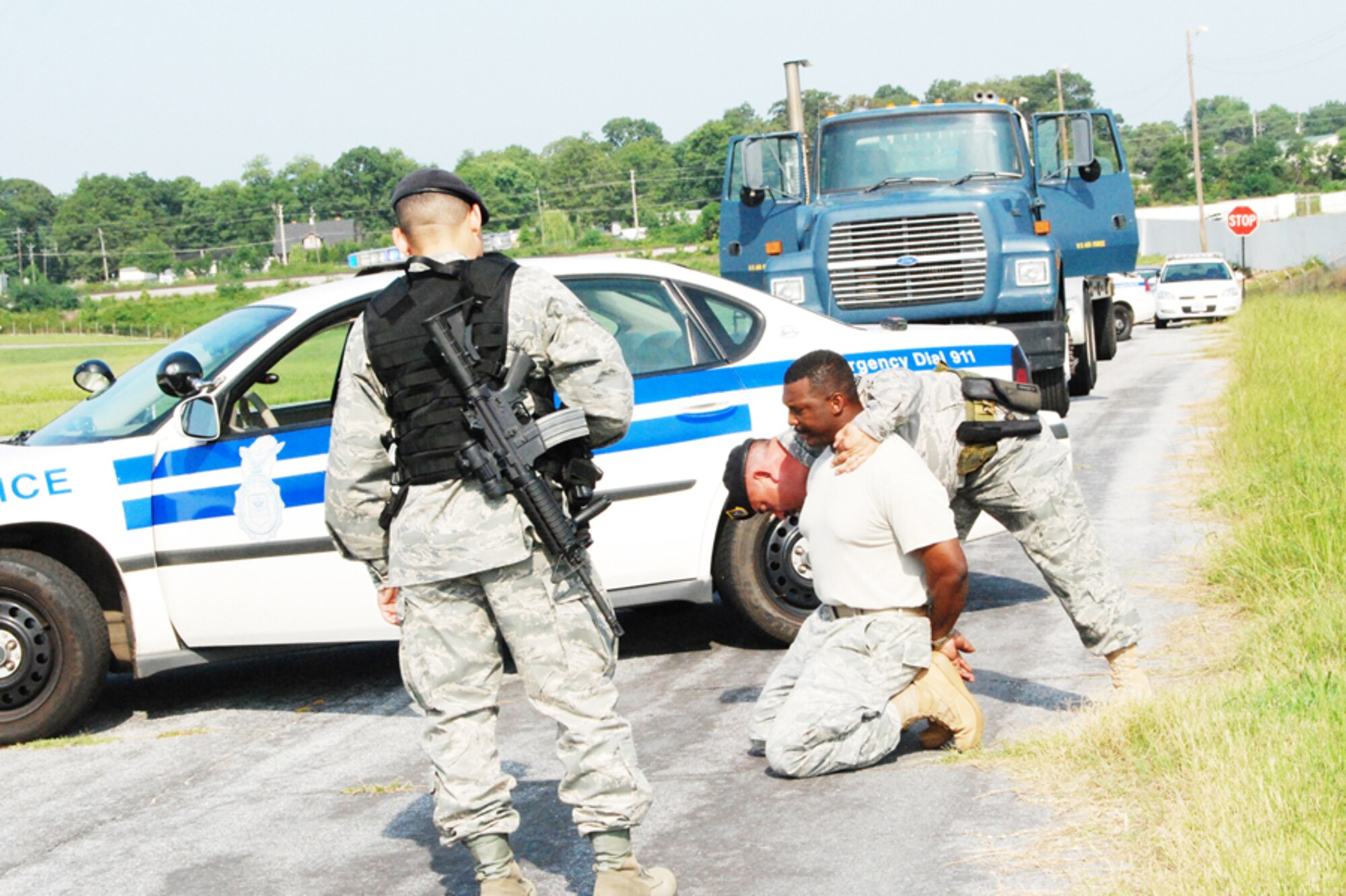 Tech. Sgt. Russell Jones, 94th Security Forces Squadron, searches a suspect who was recently detained for entering the base without authorization during an exercise Aug. 6. The simulated excercise focused on the proper procedure regarding unauthorized vehicles entering base. (U.S. Air Force photo/Kennith Green)