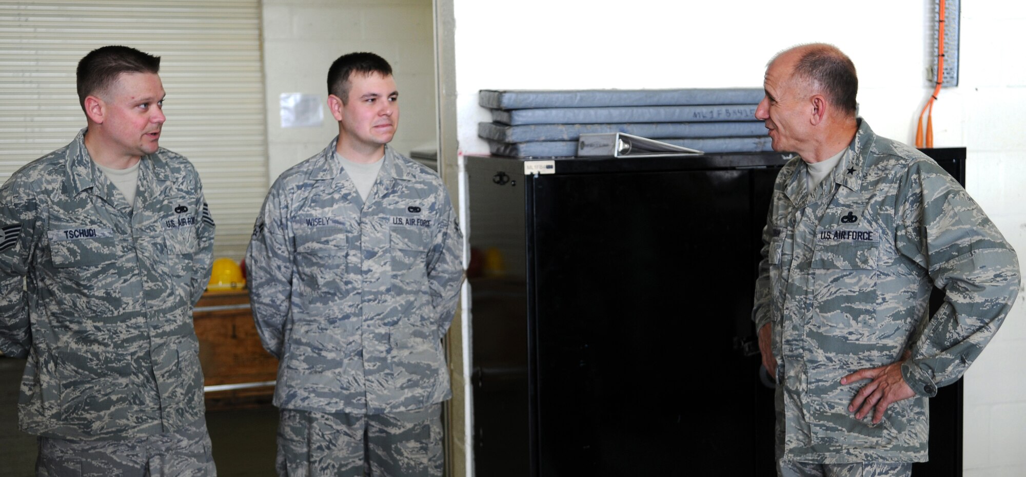 RAF MILDENHALL, England -- Brig. Gen. Mark Atkinson, U.S. Air Forces in Europe director of logistics, installations and mission support (right), speaks with Tech. Sgt. Martin Tschudi (left) and Airman 1st Class Joshua Wisely, both 100th Aircraft Maintenance Squadron Airmen, during a site visit here Aug. 6. Sergeant Tschudi and Airman Wisely explained the operations tempo of the 100th AMXS Fuel Cell and how they overcome the complications of working in England's changing weather. (U.S. Air Force photo by Senior Airman Thomas Trower)