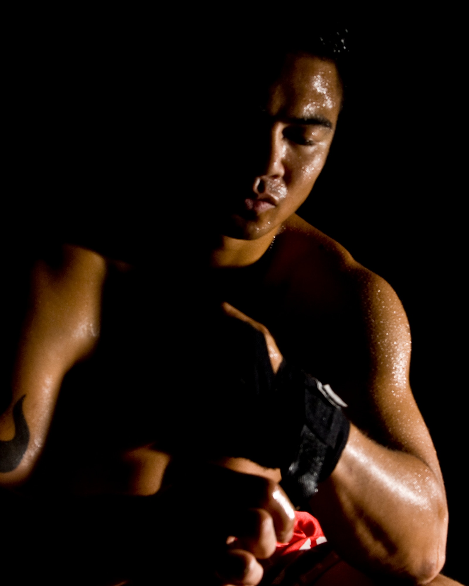 Staff Sgt. Michael Limiac, a 39th Medical Support Squadron medical information systems technician, wraps his hands prior to a mixed martial arts training session Friday, Aug. 7, 2009 in the Fitness Center at Incirlik Air Base, Turkey.  Sergeant Limiac coordinates the workout sessions three times per week.  Participants of all skill levels attend the workouts and train to build on their knowledge of the sport.   More than 20 Airmen have attended the workouts since implementation.  (U.S. Air Force photo/Staff Sgt. Raymond Hoy)