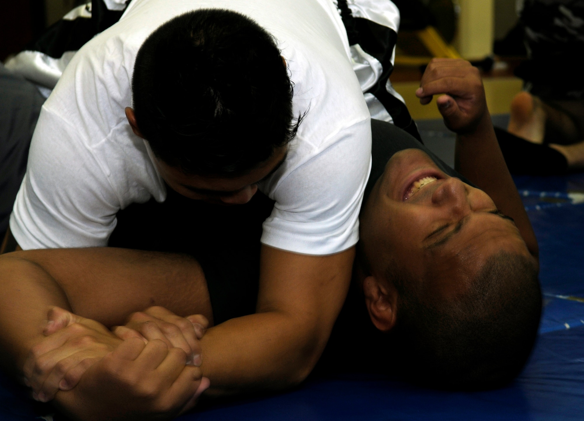 Staff Sgt. Michael Limiac, a 39th Medical Support Squadron medical information systems technician, gets Staff Sgt. Roberto Cruz, a 39th Comptroller Squadron budget analyst, in an arm lock during a mixed martial arts training session Friday, Aug. 7, 2009 in the Fitness Center at Incirlik Air Base, Turkey.  Sergeant Limiac coordinates the workout sessions three times per week.  Participants of all skill levels attend the workouts and train to build on their knowledge of the sport.   More than 20 Airmen have attended the workouts since implementation.  (U.S. Air Force photo/Staff Sgt. Raymond Hoy)