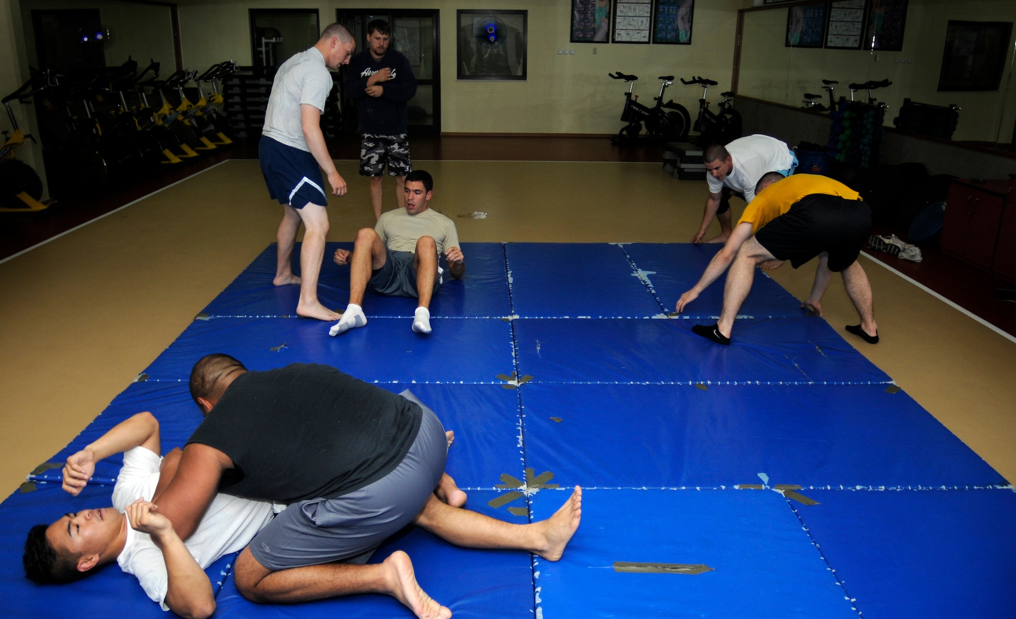 Epitomizing the warrior spirit, members of Team Incirlik train in mixed martial arts Friday, Aug. 7, 2009 in the Fitness Center at Incirlik Air Base, Turkey.  Staff Sgt. Michael Limiac, a 39th Medical Support Squadron medical information systems technician, coordinates the workout sessions three times per week.  Participants of all skill levels attend the workouts and train to build on their knowledge of the sport.   More than 20 Airmen have attended the workouts since implementation.  (U.S. Air Force photo/Staff Sgt. Raymond Hoy)