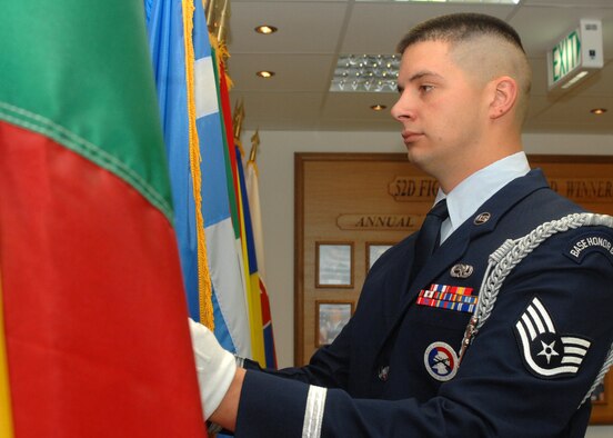 SPANGDAHLEM AIR BASE, Germany -- Staff Sgt. Justin Lemmon, 52nd Equipment Maintenance Squadron, adjust the flags outside the command section in 52nd Fighter Wing’s headquarters Aug. 5. Sergeant Lemmon was recently selected to become a member of the Air Force Honor Guard. He learned of the opportunity to join this organization when the team performed at Spangdahlem Aug. 2, 2007. (U.S. Air Force photo/Senior Airman Jenifer H. Calhoun)