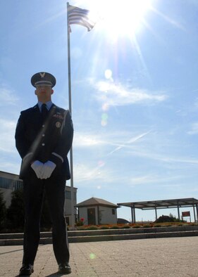 SPANGDAHLEM AIR BASE, Germany -- Staff Sgt. Justin Lemmon, 52nd Equipment Maintenance Squadron, stands in front of the American flag in front of the 52nd Fighter Wing’s headquarters Aug. 5.  Sergeant Lemmon was recently selected to be a member of the Air Force Honor Guard after completing an extensive package that included a physical profile, enlisted performance reports and photos. He will complete three-months of technical training and go onto complete a three year controlled tour with the Air Force Honor Guard at Bolling Air Force Base, Washington, D.C. (U.S. Air Force photo/Senior Airman Jenifer H. Calhoun)