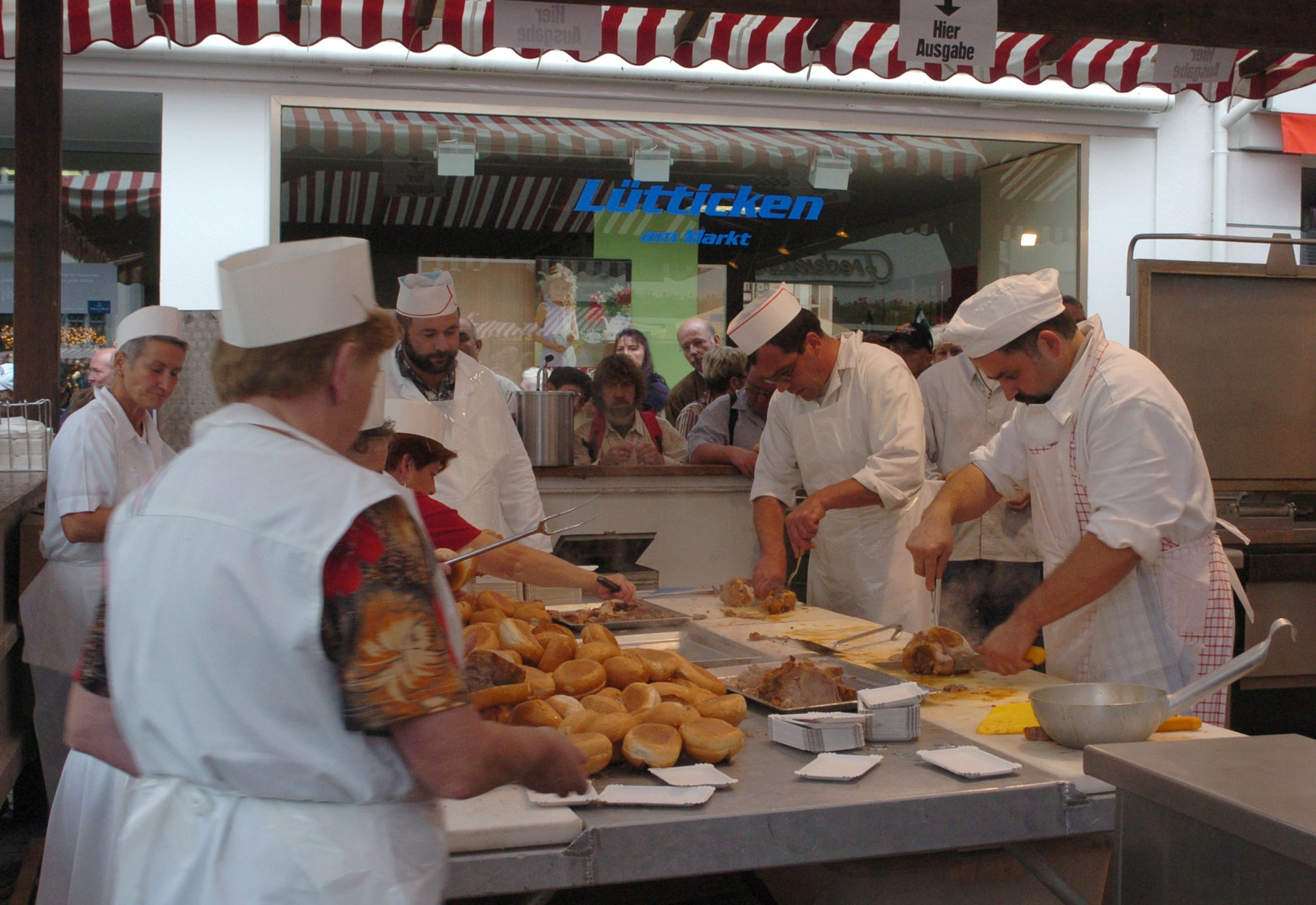 WITTLICH, Germany -- Local cooks prepare pork before serving it to visitors at the Wittlich pig festival. More than 100 pigs are roasted every year during the popular annual festival. The festival will be held Aug. 14-17. (File photo by Iris Reiff)
