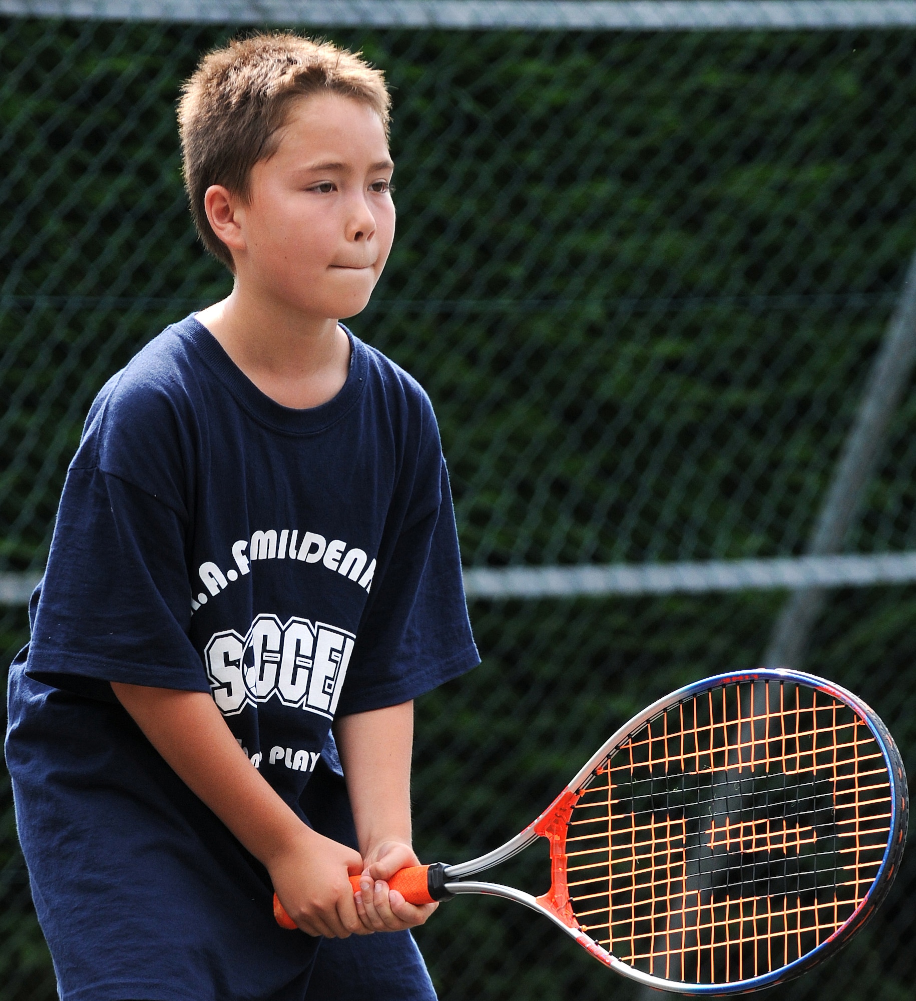 RAF MILDENHALL, England -- Keanu McElroy awaits a serve from the opposing team during a game of Elimination Aug. 6 at the Middleton Hall tennis courts. Keanu was one of eight kids participating in the Mildenhall Youth Programs camp, the second of two this summer. A volleyball camp is being offered by Mildenhall Youth Programs from Aug. 17 to 18 from noon to 2 p.m. To register, call DSN 238-2831. (U.S. Air Force photo by Senior Airman Thomas Trower)