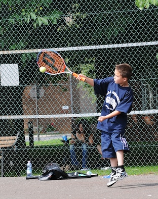 RAF MILDENHALL, England -- Keanu McElroy returns a serve during a Mildenhall Youth Programs tennis camp at the Middleton Hall tennis courts Aug. 6. Eight kids participated in the camp, which was the second of two this summer. Mildenhall Youth Programs, operated through the youth center, provides a variety of camps throughout the year from tennis to soccer. A volleyball camp is being offered from Aug. 17 to 18 from noon to 2 p.m. To register, call DSN 238-2831. (U.S. Air Force photo by Senior Airman Thomas Trower)