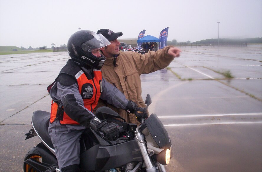Master Sgt Thomas Wright of the Joint Analysis Center, braves the rain with Andy Ibbot from the California Superbike School.