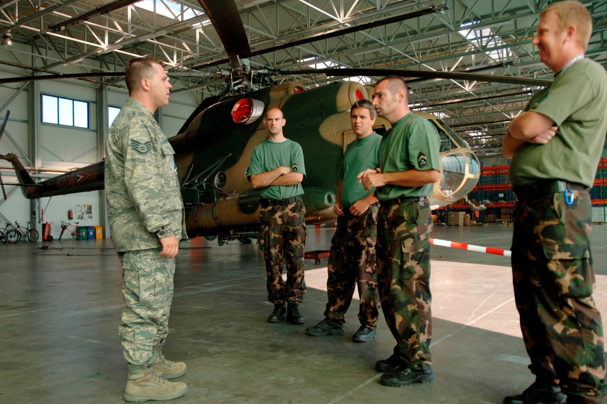 U.S. Air Force aerial transportation specialist Staff Sgt. Attila Csipes coordinates training for Hungarian Air Force personnel at Papa Air Base, Hungary. Sergeant Csipes, a native-Hungarian with U.S. citizenship, is on a three-year special duty assignment to help stand up a first-of-its-kind multinational Heavy Airlift Wing that will utilize the C-17 to provide strategic airlift to the European Union, United Nations and NATO.  (Department of Defense photo: Master Sgt. Scott Wagers)