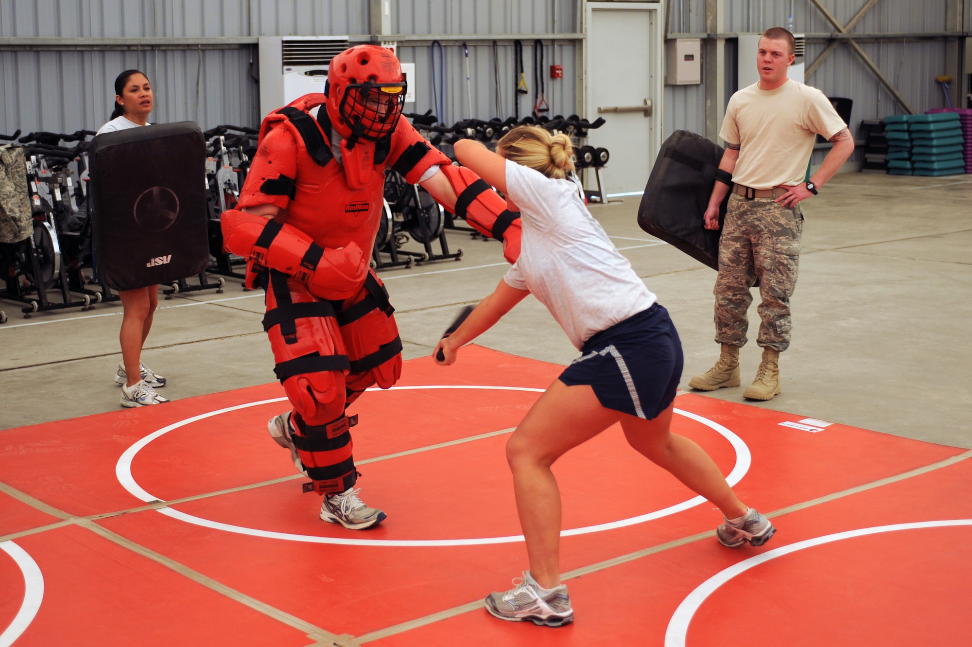 SOUTHWEST ASIA -Senior Airman Audrey Steele, 380th Expedition Security Forces Squadron, swings her simulated baton at Tech. Sgt. Anthony Burleson, 380th ESFS, while learning self defense tactics Aug 7. Airman Steele is
deployed from Lackland Air Force base, Texas, and hails from Lisbon, Ohio. Sergeant Burleson is deployed from Tinker AFB, Okla., and hails from Sweetwater, Texas.  (U.S. Air Force photo/Tech. Sgt. Charles Larkin Sr)