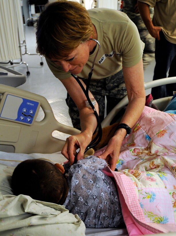 Army Maj. Una Alderman, chief nurse officer for the 452nd Army Reserve, from Wisconsin, tends to a patient at the hospital on Forward Operating Base Salerno, Afghanistan, Aug. 5, 2009. She is stationed in the same area of operations as her son, Army Staff Sgt. Seth Alderman, a military policeman with the 25th Infantry Division’s 4th Brigade Combat Team. U.S. Army photo by Pfc. Andrya Hill