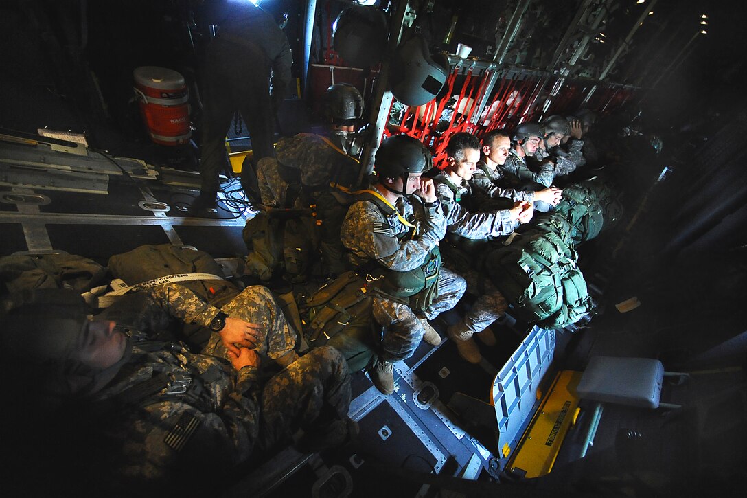 U.S. Army Rangers aboard an MC-130 Combat Talon wait for the aircraft to fly over the Fryar Drop Zone on Fort Benning, Ga., Aug. 3, 2009.