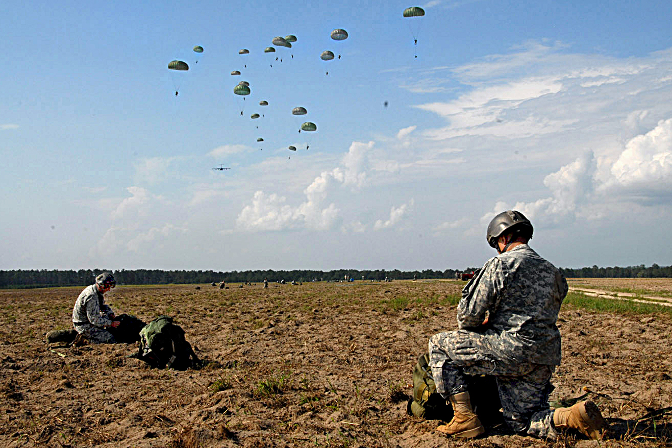 U.S Army Rangers gather their parachutes as part of a mass tactical airborne operation after