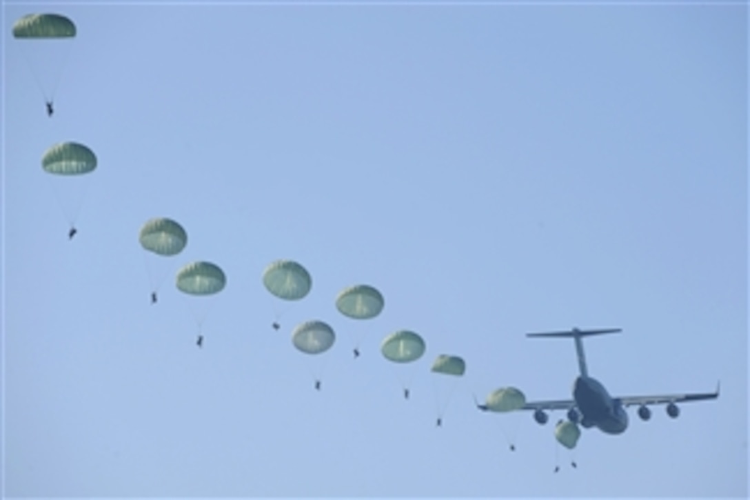 U.S. Army rangers parachute from an Air Force C-17 Globemaster III aircraft during a mass tactical jump over Fryar Drop Zone at Fort Benning, Ga., on Aug. 3, 2009.  The jump is the opening exercise of Ranger Rendezvous 2009, a week-long event that provides an opportunity for members of the 75th Ranger Regiment to showcase their tactics and abilities to family members and ranger veterans.  