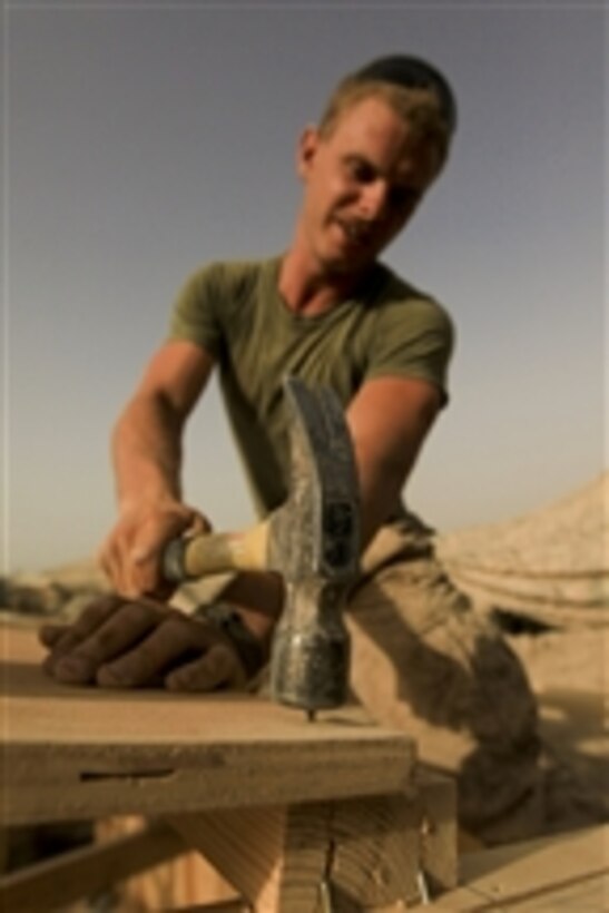 U.S. Marine Corps Sgt. Chris Meechum with Alpha Company, 1st Battalion, 5th Marine Regiment helps construct a building at the company's operating base in the Nawa district of Helmand province, Afghanistan, on Aug. 3, 2009.  Marines with 1st Battalion, 5th Marine Regiment, Regimental Combat Team 3, 2nd Marine Expeditionary Brigade-Afghanistan are deployed to support NATO's International Security Assistance Force and will participate in counter insurgency operations.  They will train and mentor Afghan National Security Forces to improve security and stability in the country.  