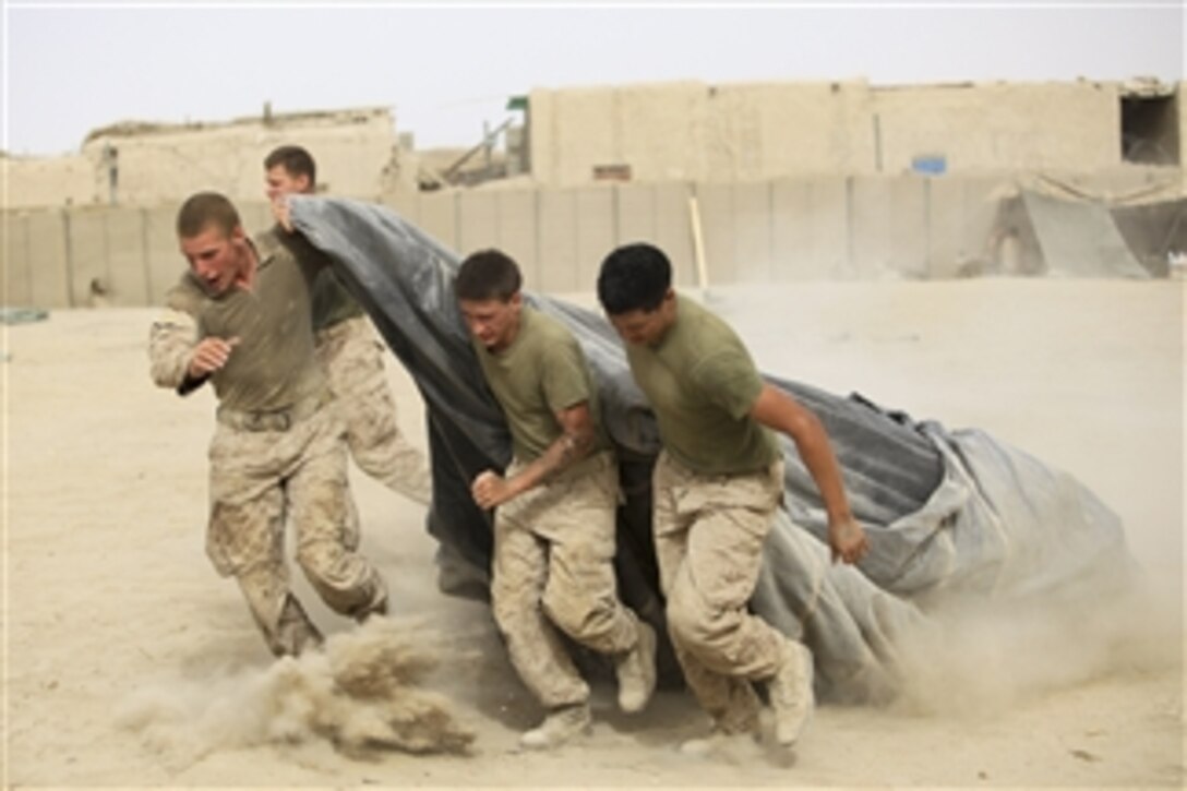 U.S. Marines with Charlie Company, 1st Battalion, 5th Marine Regiment pull a parachute across camp at Patrol Base Jaker in the Nawa district of Helmand province, Afghanistan, on Aug. 5, 2009.  The parachute will protect their water supply from the heat of the sun.  Marines with 1st Battalion, 5th Marine Regiment, Regimental Combat Team 3, 2nd Marine Expeditionary Brigade-Afghanistan are deployed to support NATO's International Security Assistance Force and will participate in counter insurgency operations.  They will train and mentor Afghan National Security Forces to improve security and stability in the country.  