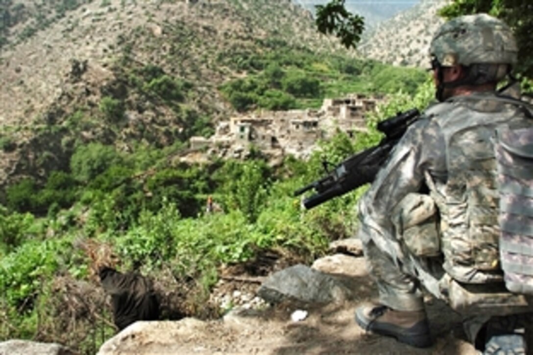 A U.S. Army soldier scans Wadawu valley during Operation Silver Creek in Nuristan province, Afghanistan, Aug. 7, 2009. The operation is a combined Afghan and coalition event to disrupt insurgents and ensure the security of local residents before the country’s second national election, scheduled for late August. The soldier is assigned to the 4th Infantry Division's Headquarters Battery, 2nd Battalion, 77th Filed Artillery Regiment.