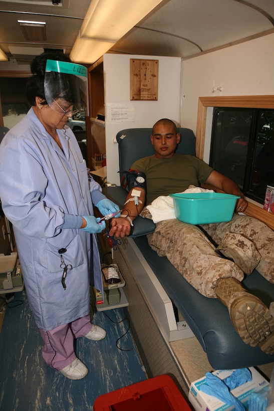 Imelda M. Leviste, a phlebotomosist with Naval Base San Diego, draws blood from Pfc. Armando M. Magana-Garibay, an aviation life support system technician with Marine Aviation Logistics Squadron 11. The “bloodmobile” collected 36 pints from the Marines of MALS-11.
