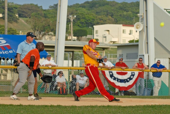 Marine Corps Air Station Iwakuni’s first baseman Chad E. Roach connects a shot to the outfield in the team’s first game during the first round of the Far East Regional Softball Tournament 2009 here Aug. 10.