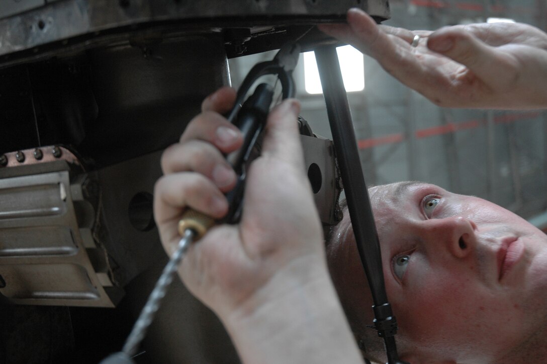 Lance Cpl. Kenneth Aoford, Marine Attack Squadron 513 airframer, safety wires bolts on an AV-8B Harrier in the squadron's hangar at the Marine Corps Air Station in Yuma, Ariz., Aug. 10, 2009. Aoford is one of approximately 150 Marines scheduled to deploy Aug. 16 and 21, 2009, in support of the 31st Marine Expeditionary Unit based in Japan. "This is going to be my first deployment," said Aoford. "I'm pretty excited, this is going to be a very new experience." While in Japan the squadron is slated to participate in exercises Ryuku Warrior, Talisman Saber and Wolmi-Do Fury.