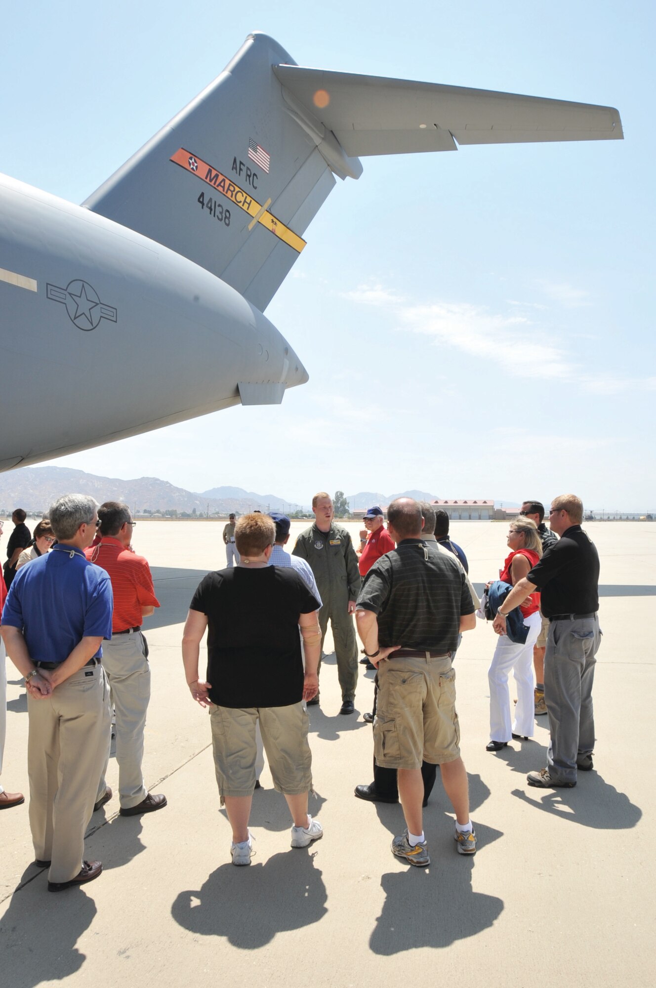 Captain Andrew Vandertoorn, a C-17 pilot with the 729th Airift Squadron at March Air Reserve Base (center in flight suit), gives a tour of a C-17 to civilian employers of Reserve and National Guard service members July 23. The employers were from cities across Nebraska and had flown on a KC-135 to March ARB for a three-day tour of military installations in California. The employers spent a full day at the base visiting the C-17s, 144th Fighter Wing Detachment 1, Air and Marine Operations Center and the Defense Media Center. The Nebraska Employer Support of the Guard and Reserve organized the "Bosslift" to provide employers a better understanding of what Guard and Reserve members do when they are performing military duties away from their civilian jobs. (U.S. Air Force Photo by Tech. Sgt. Alex R. Salmon)