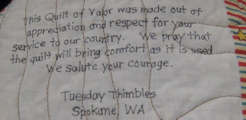Hundreds of individual quilters and quilting clubs from every region of the nation make Quilts of Valor. This label is on a quilt donated by the Tuesday Thimbles quilting club of Spokane, Wash., and is one of several such quilts reviewed by Angie Carr and Capt. Sandra Bannon of the Air Force Mortuary Affairs Operations Center located at Dover A.F.B., Del., on June 12, 2009. (U.S. Air Force photo/Tech. Sgt. Benjamin Matwey) 