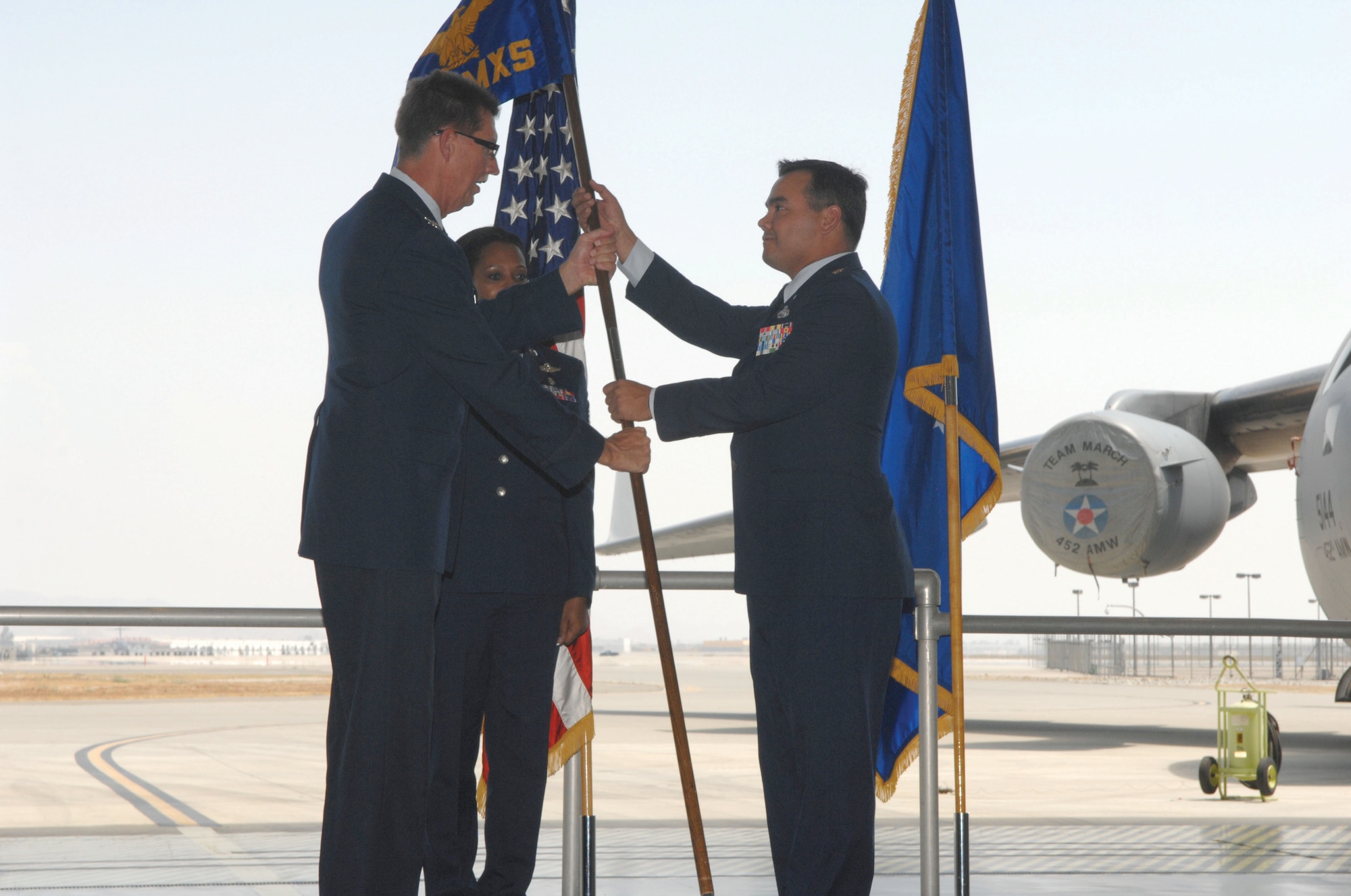 Col. Robert R. Stormes, 452nd Maintenance Group commander, left, passes the guidon to Major Kevin M. Davis who assumes command of the 452nd Aircraft Maintenance Squadron.  (U.S. Air Force photos by Staff Sgt. Angel Gallardo)