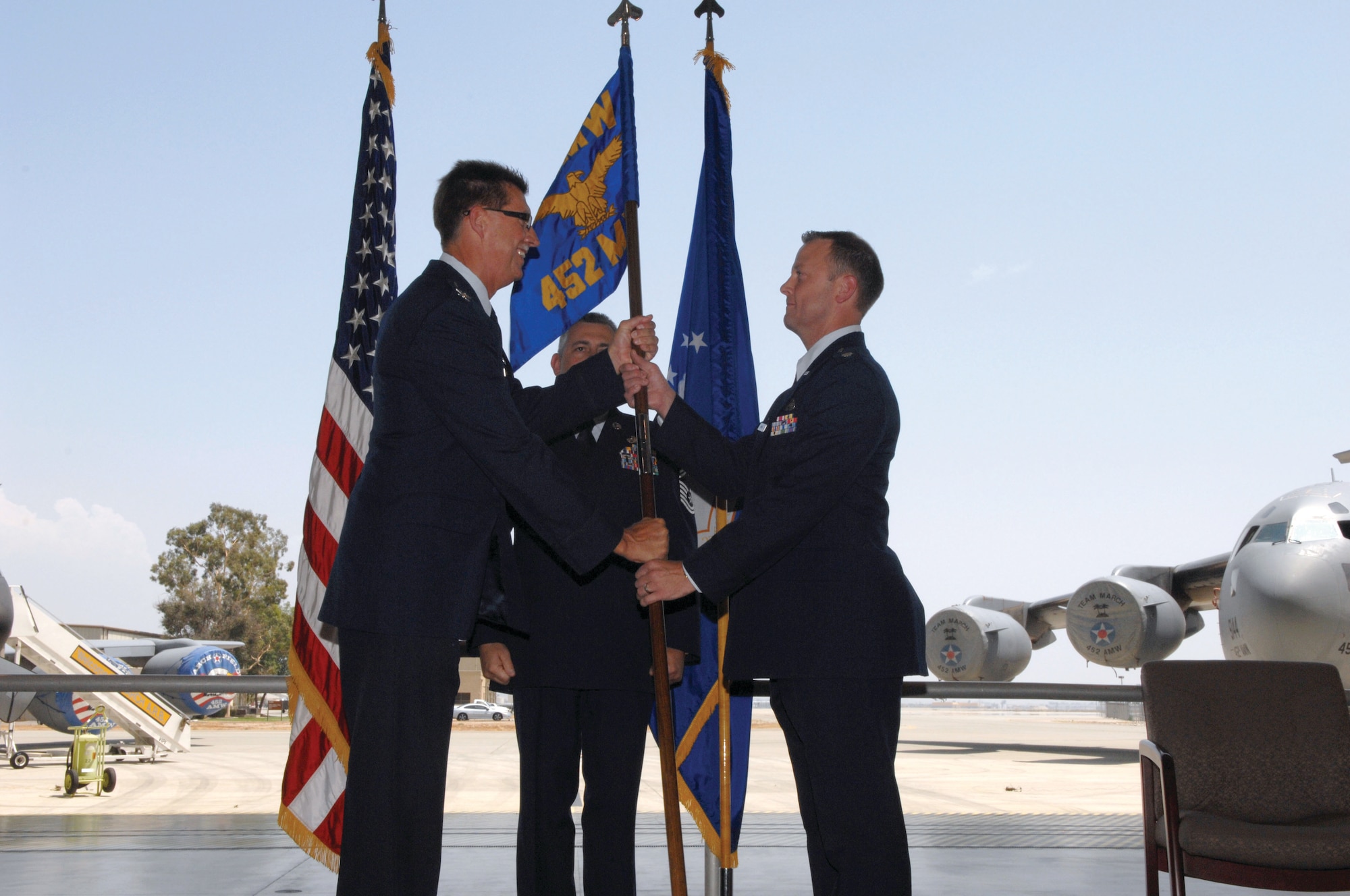 Col. Robert R. Stormes, 452nd Maintenance Group commander, left, passes the guidon to the new 452nd Maintenance Squadron commander Lt. Col. Mark S. Baker. (U.S. Air Force photos by Staff Sgt. Angel Gallardo)