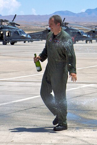NELLIS AIR FORCE BASE, Nev. -- Col. Jimmy 'J Ray' Clark, commander of Air Force Operational Test and Evaluation Center, Detachment 6, gets hosed down after his final flight July 27.  Colonel Clark retired after 28 years of service as an F-15C pilot Aug. 5. (courtesy photo)