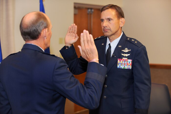 Retired Maj. Gen. Lawrence Johnston, former U.S Air force Warfare Center commander,  administers the oath of office to the recently promoted Maj. Gen. Ted Kresge, USAFWC commander,  during his promotion ceremony Aug. 10, 2009 at Nellis Air Force Base, Nev. The USAFWC's mission is to shape the way our force fights through operational testing, tactics development, and advanced training in air, space, and cyberspace at the operational and tactical levels. (U.S. Air Force Photo/Tech. Sgt. Michael R. Holzworth)
