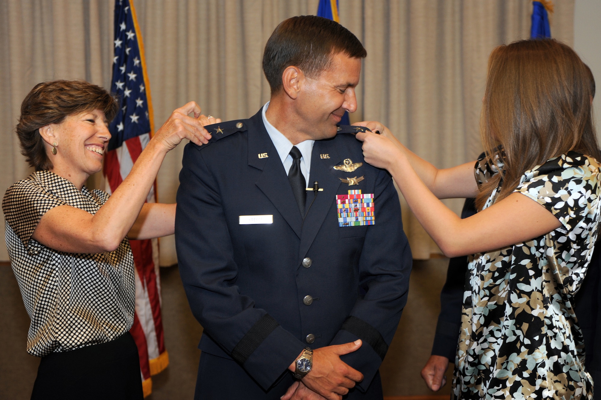 Lorie and Diana Kresge pin-on a second star at the promotion ceremony for Maj. Gen. Ted Kresge, U.S. Air Force Warfare Center commander,  Aug. 10, 2009 at Nellis Air Force Base, Nev.The USAFWC's mission is to shape the way our force fights through operational testing, tactics development, and advanced training in air, space, and cyberspace at the operational and tactical levels. (U.S. Air Force Photo/Tech. Sgt. Michael R. Holzworth)
(U.S. Air Force Photo/Tech. Sgt. Michael R. Holzworth)