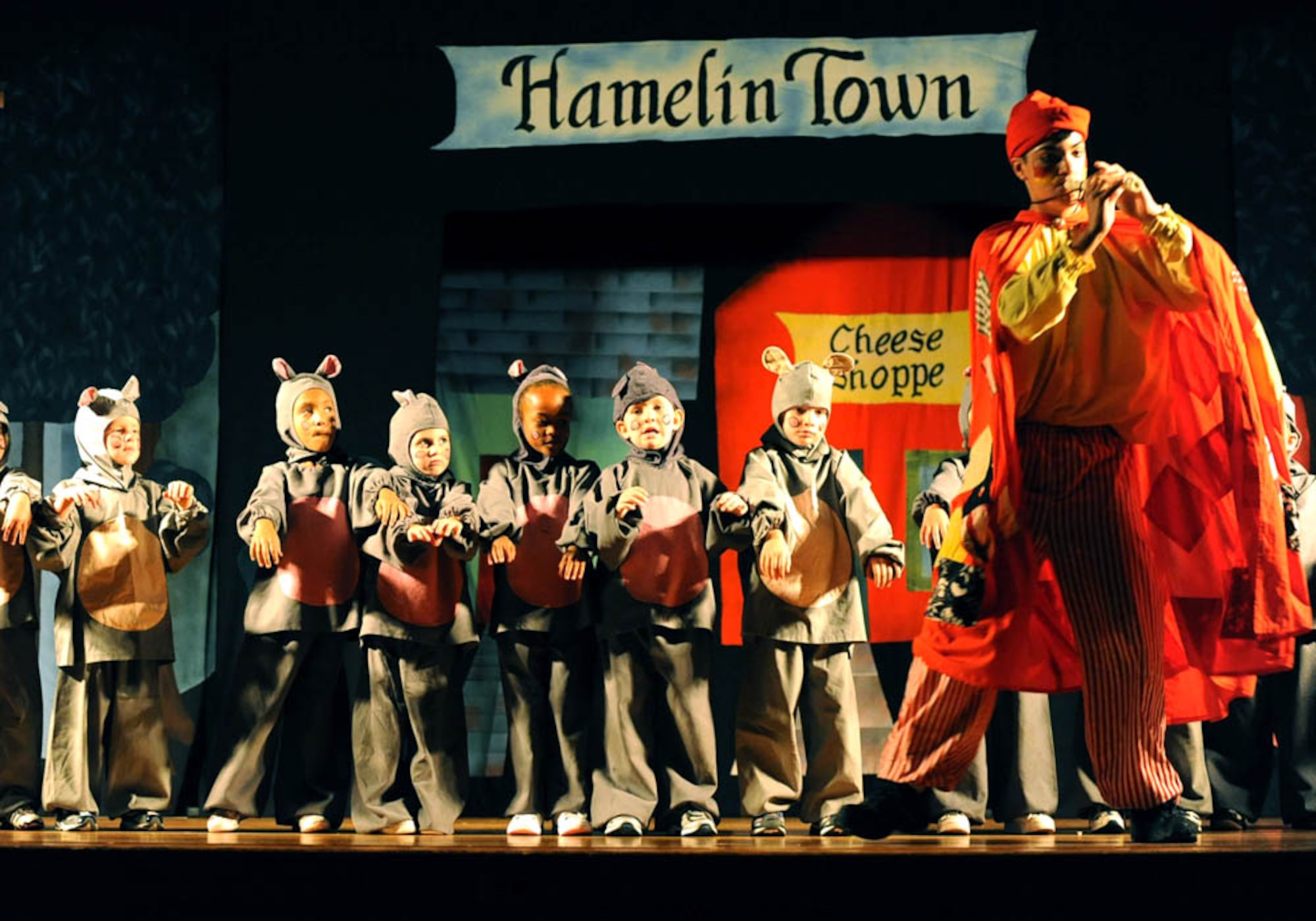 DYESS AIR FORCE BASE, Texas—Matthew Starr, the Pied Piper, lures the rats of Hamelin with magical tunes from his pipe here Aug. 7. Fifty-seven children prepared less than a week for the performance. More than 65,000 children will perform in the Missoula Children’s Theatre International Tour Project this year. (U.S. Air Force photo by Senior Airman Domonique Washington)