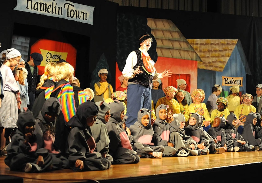 DYESS AIR FORCE BASE, Texas—Cast members assemble on stage during the final scene of the Pied Piper at the base theater here Aug. 7. Fifty-seven children from Dyess Air Force Base prepared less than a week for the performance. More than 65,000 children will perform in the Missoula Children’s Theatre International Tour Project this year.  (U.S. Air Force photo by Domonique Washington) 