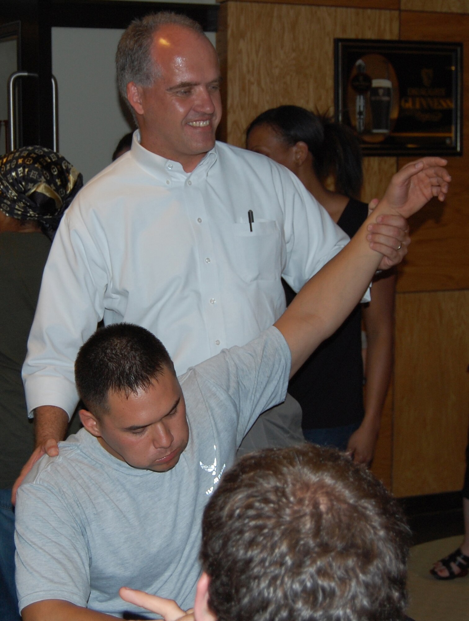 OFFUTT AIR FORCE BASE, Neb. - John Kundinger, 55th Mission Support Group deputy comander, raises the victorious hand of Senior Airman Michael Makala, a personnelist from the Military Reenlistment Office here, at the conclusion of the Extreme Steak Challenge Aug. 7 in the Patriot Club MVP Lounge. Airman Makala was the only contestant to win $50 for eating his entire 96 oz. steak, piece of corn, baked potato and side salad. U.S. Air Force photo by Airman 1st Class Peter R.O. Danielson.