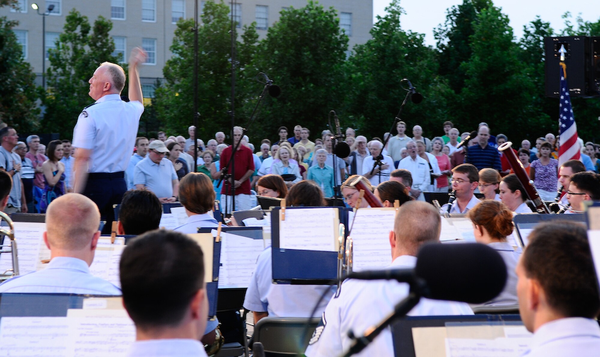 Lt. Col. Alan C. Sierichs, United States Air Force Band commander and music director, leads the crowd in the singing of the National Anthem at the Air Force Memorial Aug. 7 in Arlington, Va. Thought the Summer, the Band performs free concerts at the Air Force Memorial Wednesdays and Fridays. The final performance date is Aug. 28 For more information call (202) 767-5658. (U.S Air Force photo by Senior Airman Alexandre Montes)