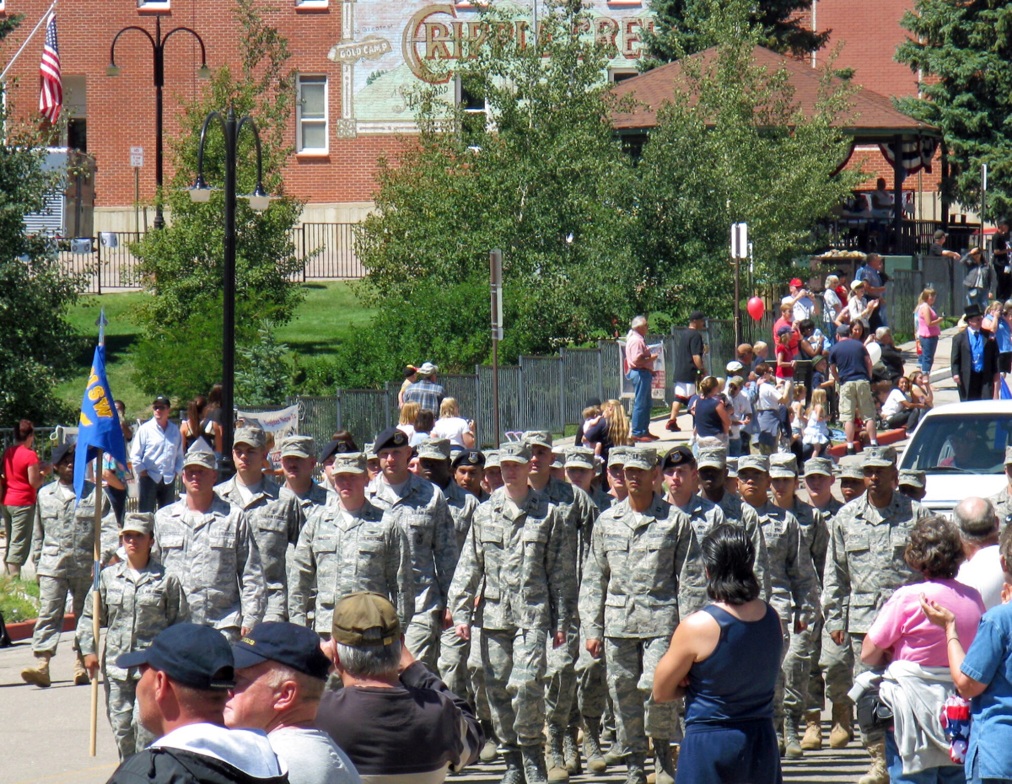 CRIPPLE CREEK, Colo. -- Airmen from the 21st Space Wing march in the 2009 Cripple Creek Honors America’s Armed Forces Parade Aug. 8. Approximately 40 local Airmen volunteered to participate in this annual community event which also featured a fireworks display, World War II reenactments and the dedication of the 2009 Memorial Wall, which features the names of El Paso County service members killed in the line of duty since Sept. 11, 2001. (Air Force photo by Tech. Sgt. Jerrme Stanton). 


