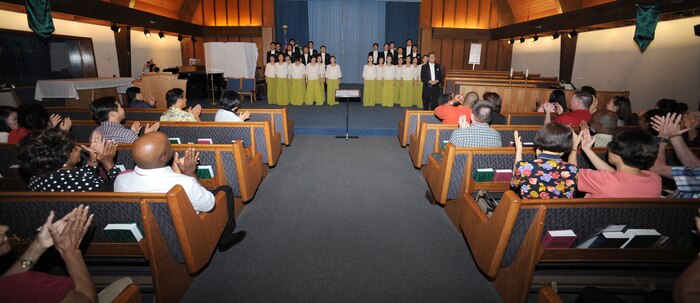 NELLIS AIR FORCE BASE, Nev. - Nellis Airmen, family and friends applaud a performance by the Chai Hoon-Cha Choir, an internationally recognized choir from Seoul, South Korea, at the base chapel, Aug. 10. The performance included seven songs, some were sang in English and others were sang in Korean. Founded in 2001, the group performed in the United States and Canada from Aug. 6 to 14.  This visit to Nellis marks a first for the Chai Hoon-Cha Choir.  (U.S. Air Force photo by Tech. Sgt. Michael R. Holzworth)