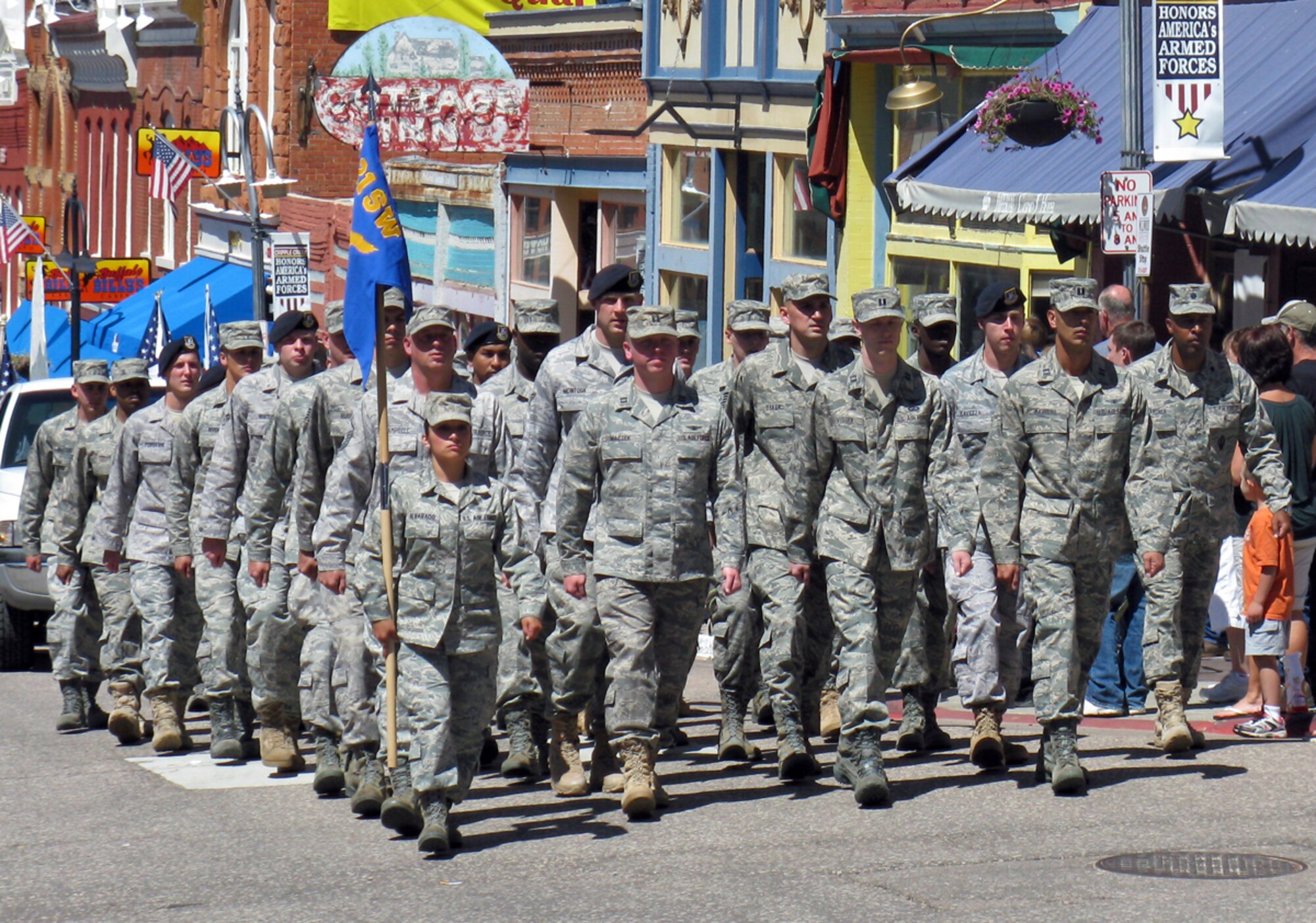 CRIPPLE CREEK, Colo. -- Airmen from the 21st Space Wing march in the 2009 Cripple Creek Honors America’s Armed Forces Parade Aug. 8. Approximately 40 local Airmen volunteered to participate in this annual community event which also featured a fireworks display, World War II reenactments and the dedication of the 2009 Memorial Wall, which features the names of El Paso County servicemembers killed in the line of duty since Sept. 11, 2001. (Air Force photo by Tech. Sgt. Jerrme Stanton). 