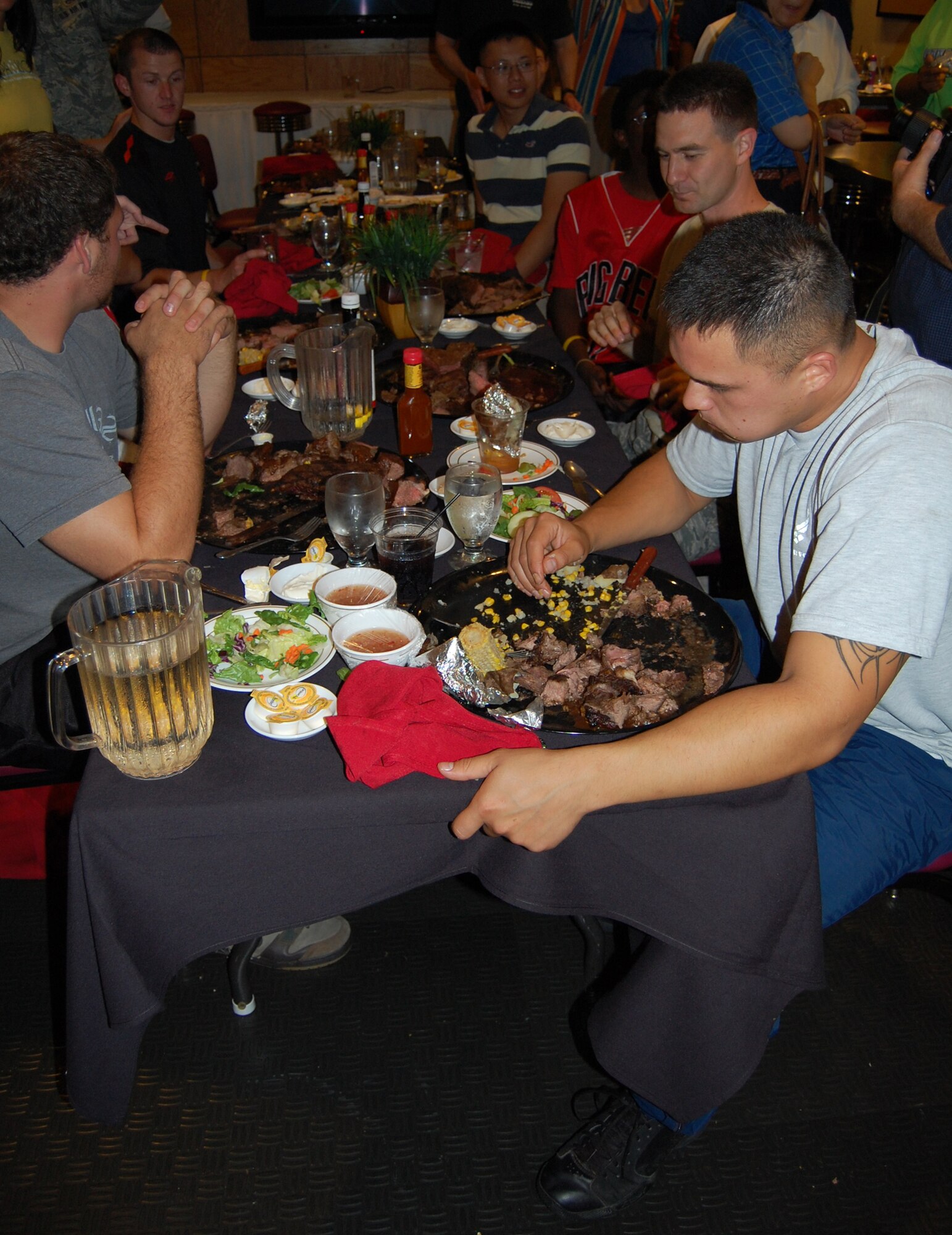 OFFUTT AIR FORCE BASE, Neb. - Contestants in the Extreme Steak Challenge recover from their attempts to eat 96 oz. steaks in the Patriot Club's MVP Lounge Aug. 7.