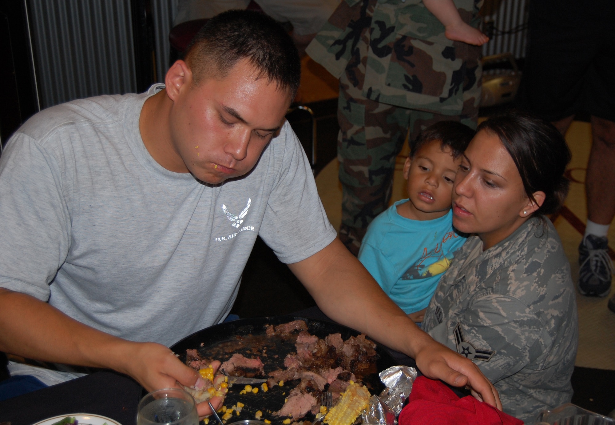 OFFUTT AIR FORCE BASE, NEB - Senior Airman Michael Makela, a personnelist with the Military Reenlistment Office, finishes his corn and potato in the final three minutes of the Extreme Steak Competition at the Patriot Club's MVP Lounge Aug. 6. Of the 10 contestants that competed, he was the only one to finish his 96 oz. steak, baked potato, corn-on-the-cob and salad.
