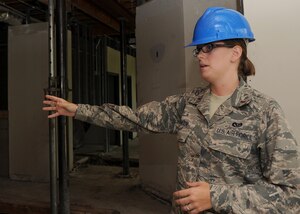 LANGLEY AIR FORCE BASE, Va. - Second Lt. Melissa Jumper, 1st Civil Engineer Squadron, explains the energy efficient renovations being made in the new Air Base Wing Headquarters building Aug. 5. Upgrades include a "greener" air conditioning system, and the installation of occupancy sensors to shut off lights automatically when there is no one in the room. (U.S. Air Force photo/Airman Rebecca Montez)