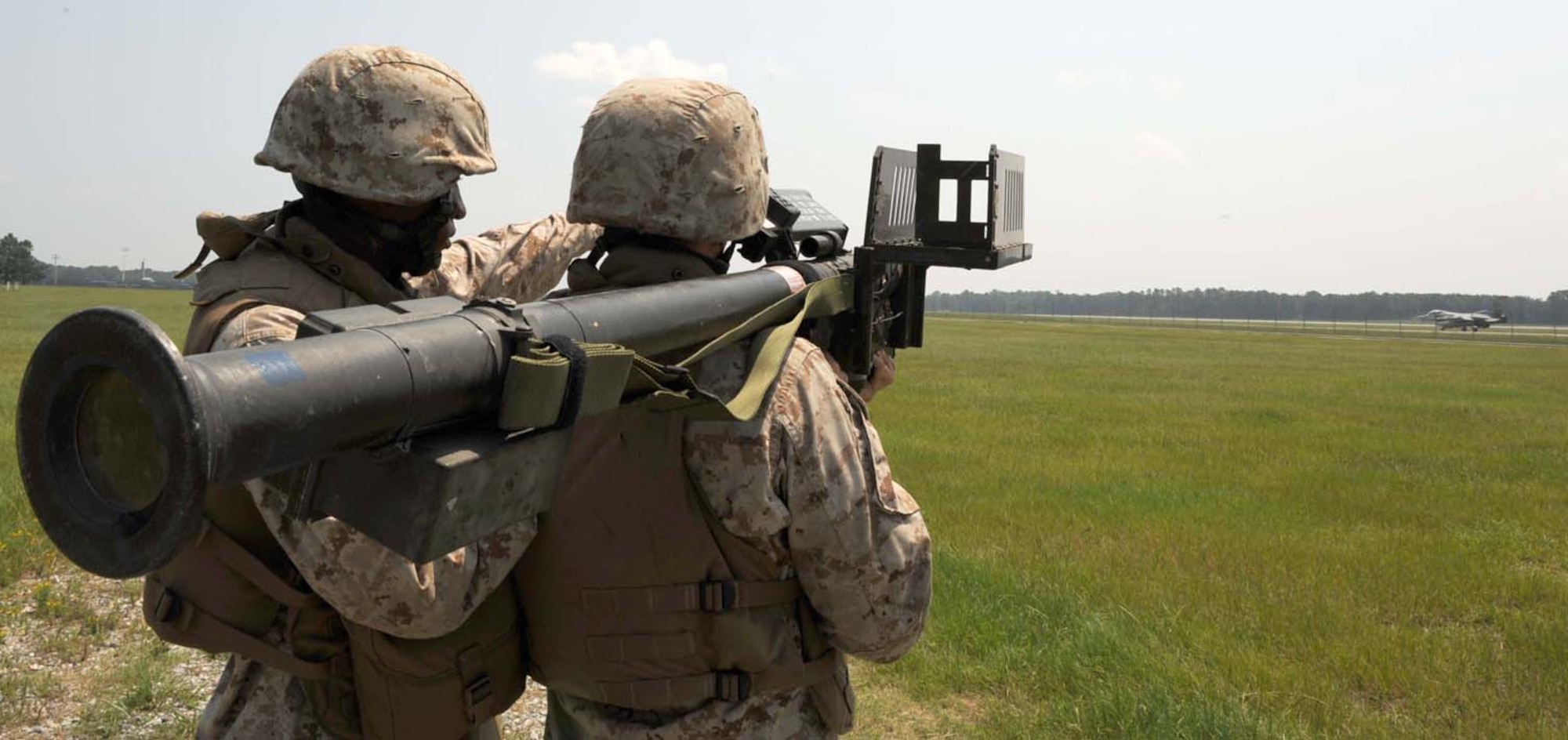 Team leader Lance Cpl. Nicholas Bingman and assistant gunner Pfc.  Robert Oliver, 2d Low Altitude Air Defense, Alpha Battery, 1st Platoon, Naval Air Station Cherry Point, N.C., simulate firing a Stinger shoulder-fired guided missile during the battle rhythm training exercise at Seymour Johnson Air Force Base, N.C., August 5, 2009. The purpose of the exercise was to allow the Marines the opportunity to target fighter aircraft. On the other end of the exercise there were a team of JTACs supporting the exercise calling in air strikes at the Dare County Bomb Range, N.C. (U.S. Air Force photo by Airman 1st Class Gino Reyes) 