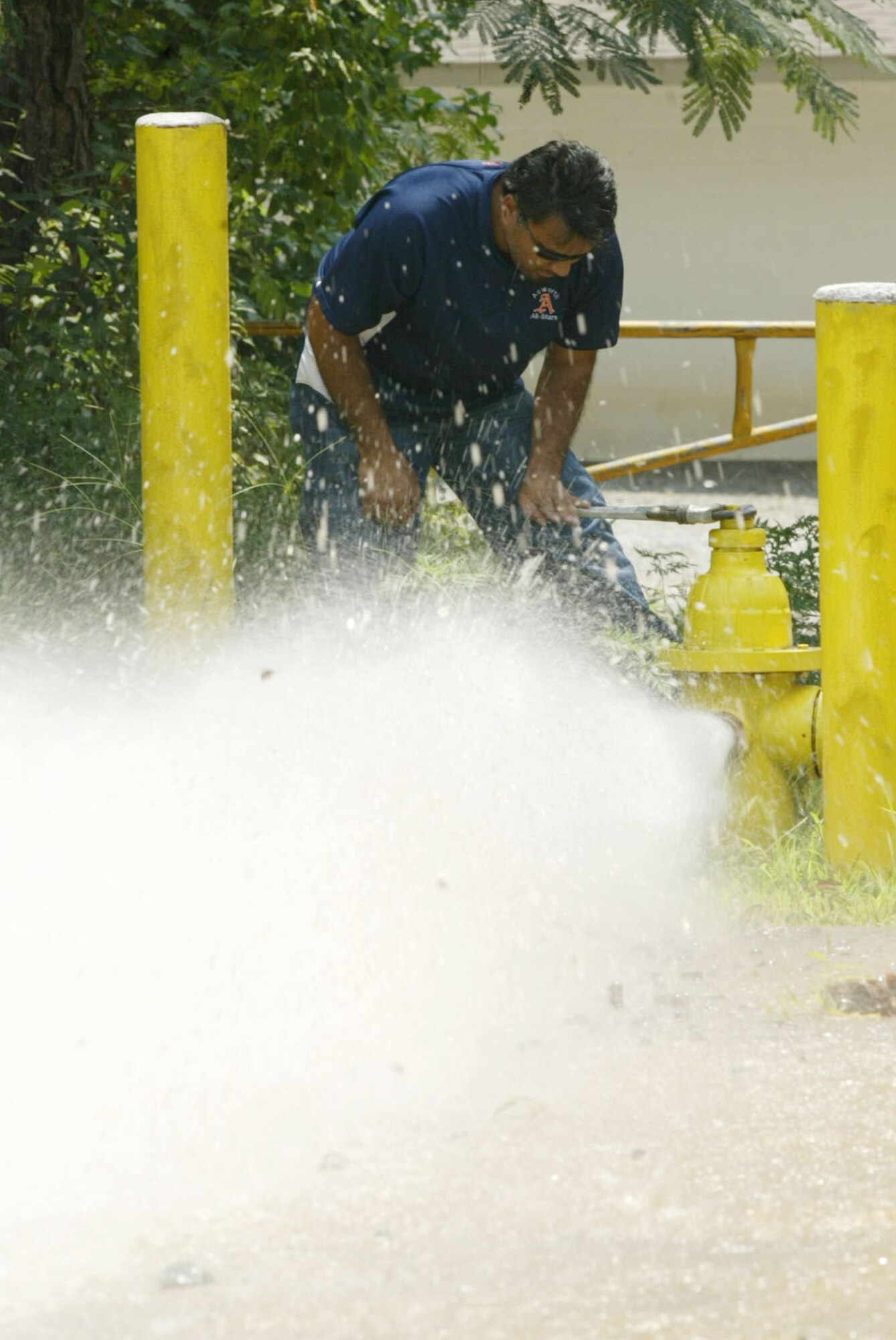 Repair crews open fire hydrants to release pressure necessary in restoring water flow back into the base water system Aug. 7. The water outage caused the base to close for nearly two business days as crews feverishly worked to restore the water by late Aug. 7. (U.S. Air Force photo/Don Peek)